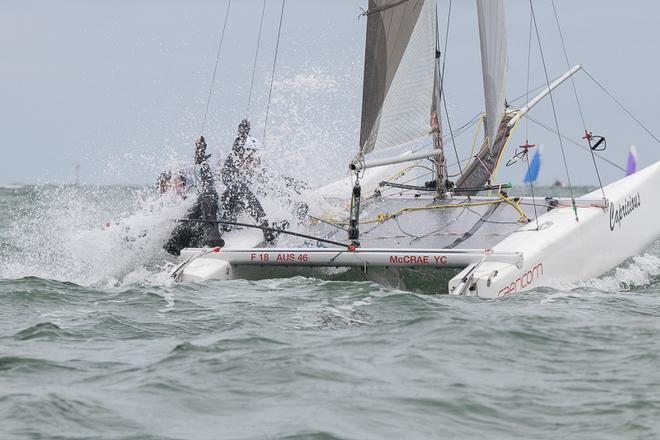 AUS46 – Busting through some Port Phillip chop with Gary Haywood and Malcolm Byrne of Victoria - Pinkster Gin 2017 F18 Australian Championship ©  Alex McKinnon Photography http://www.alexmckinnonphotography.com